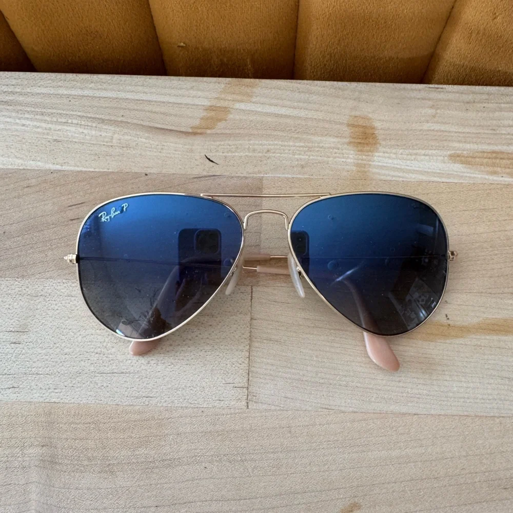 Ray-Ban Gold Frame Sunglasses with polarized Blue Lenses.